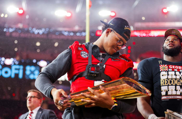 Nolan Smith with the 2023 national championship trophy after the Georgia Bulldogs defeated TCU by a score of 65-7